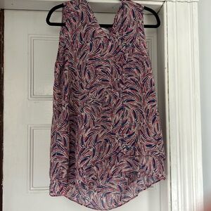 100% polyester sleeveless top. Ruffle around bottom
